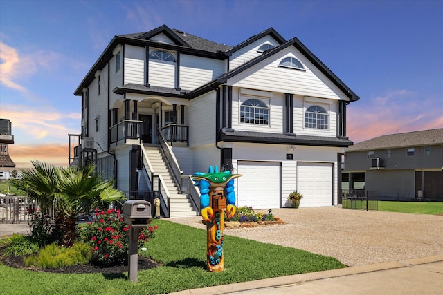 view of front of property featuring a garage and a lawn