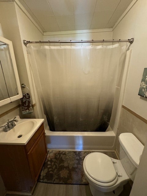 full bathroom featuring shower / tub combo with curtain, vanity, toilet, and hardwood / wood-style flooring