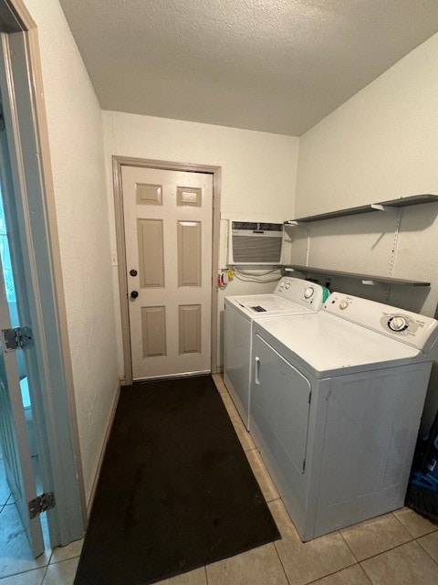 laundry area with light tile flooring and washing machine and clothes dryer