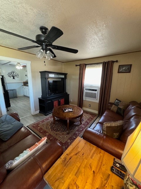 living room featuring a textured ceiling and ceiling fan