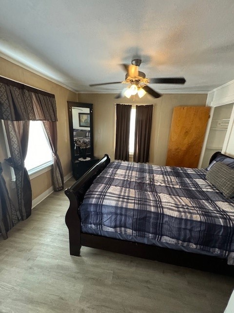 bedroom featuring light hardwood / wood-style floors and ceiling fan