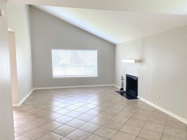 unfurnished living room with light tile patterned floors and high vaulted ceiling