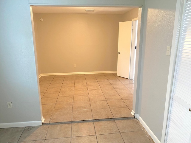 hallway featuring light tile patterned flooring