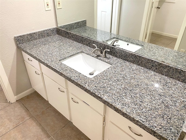 bathroom with tile patterned floors and vanity