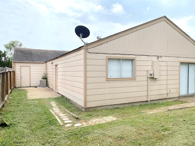 view of side of property with a lawn