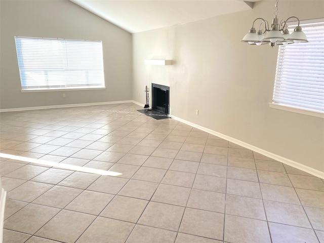 unfurnished living room with a notable chandelier, light tile patterned floors, and vaulted ceiling