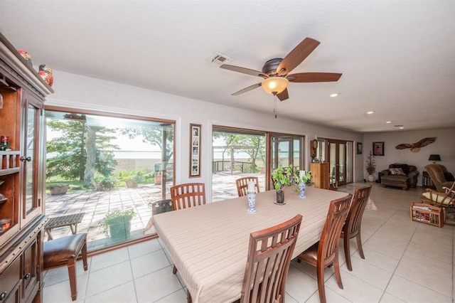 tiled dining room featuring ceiling fan