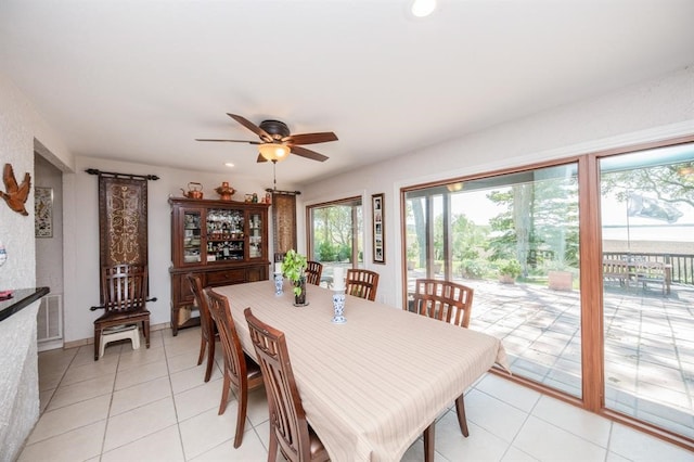 dining room featuring ceiling fan and light tile floors