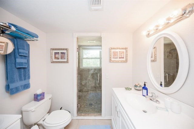 bathroom featuring a shower with door, vanity, toilet, and tile flooring