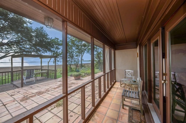 unfurnished sunroom featuring wooden ceiling and a healthy amount of sunlight