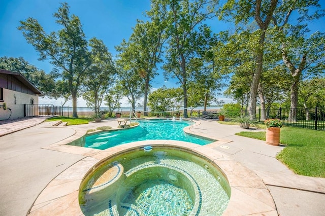 view of swimming pool featuring an in ground hot tub and a patio area