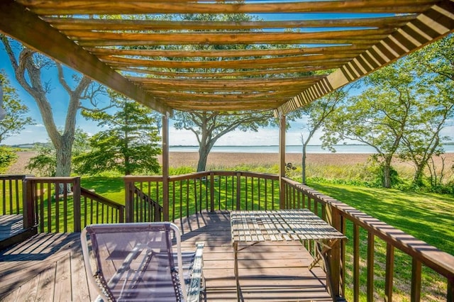 deck with a water view, a lawn, and a pergola