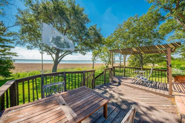 deck featuring a water view, a yard, and a pergola