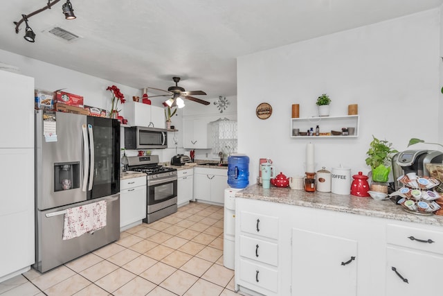 kitchen with white cabinets, light tile flooring, appliances with stainless steel finishes, sink, and ceiling fan