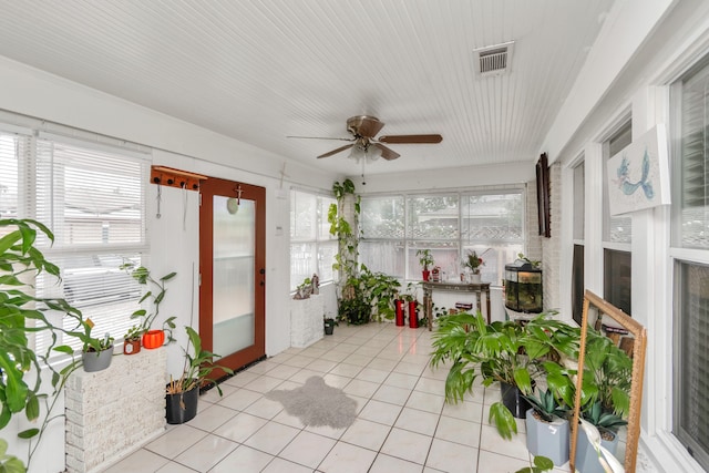 sunroom featuring ceiling fan