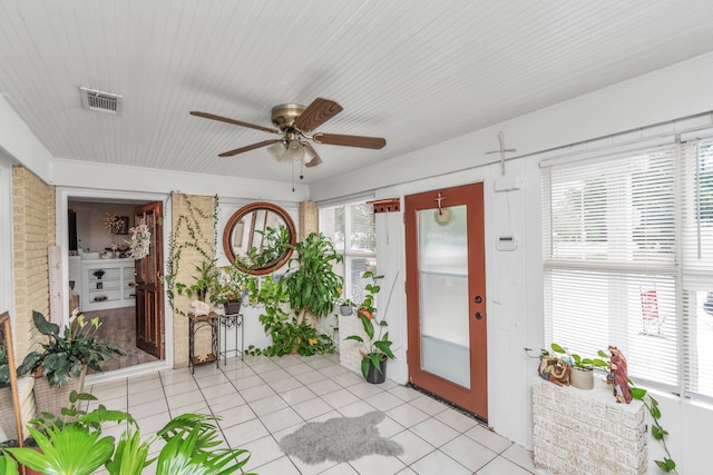 unfurnished sunroom featuring ceiling fan