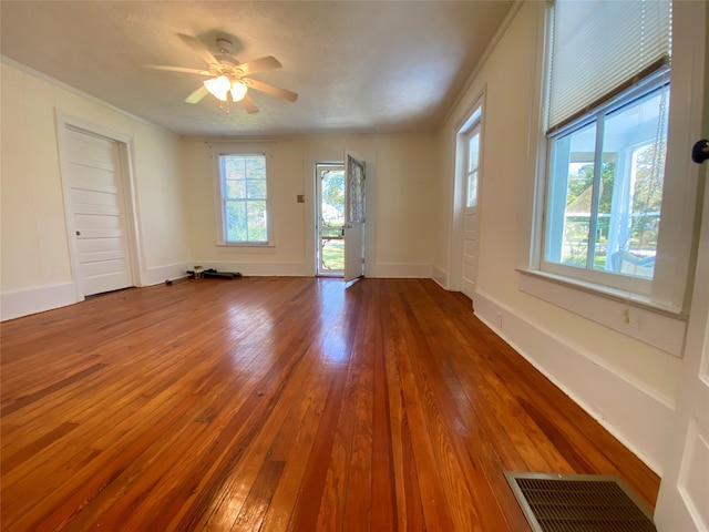 spare room featuring crown molding, hardwood / wood-style flooring, and ceiling fan