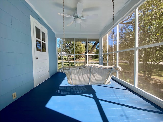 unfurnished sunroom with ceiling fan