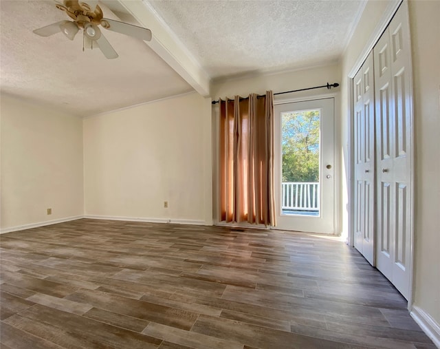 interior space with beam ceiling, a textured ceiling, dark hardwood / wood-style floors, and ceiling fan