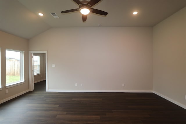 spare room featuring ceiling fan, dark hardwood / wood-style flooring, and vaulted ceiling