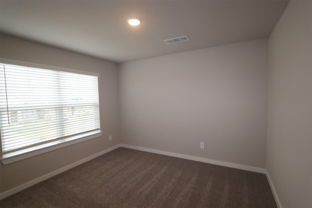 empty room featuring dark colored carpet