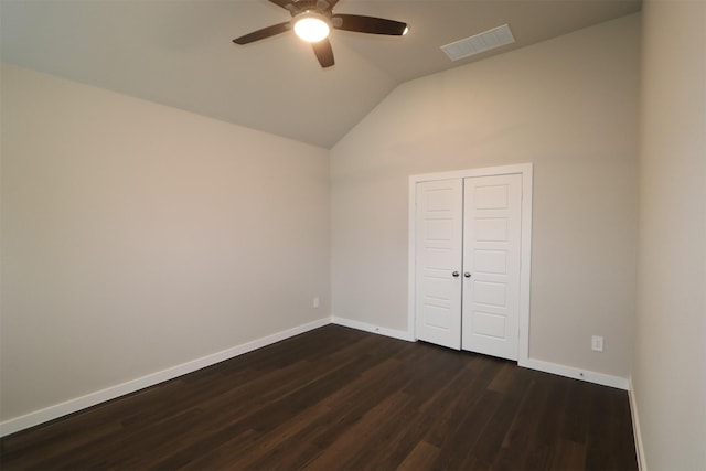 unfurnished bedroom with ceiling fan, dark wood-type flooring, a closet, and vaulted ceiling