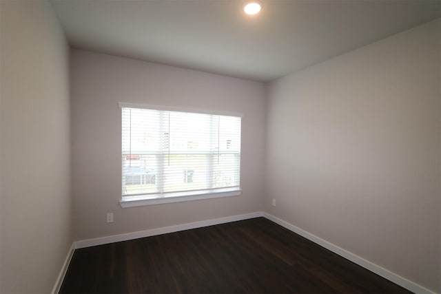 spare room featuring dark wood-type flooring