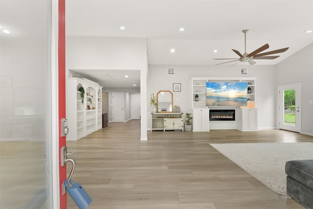 living room featuring ceiling fan and light hardwood / wood-style floors