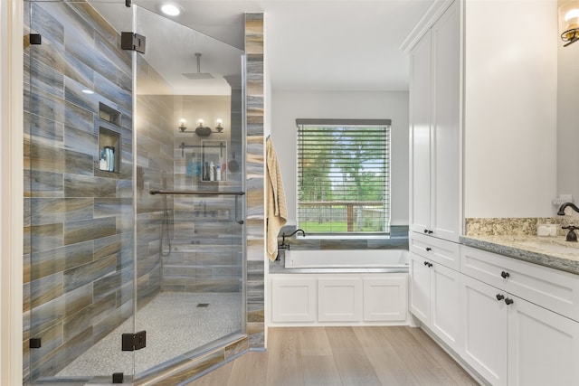 bathroom with vanity, separate shower and tub, and hardwood / wood-style flooring