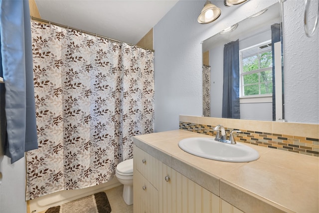 bathroom featuring vanity, tasteful backsplash, curtained shower, tile patterned floors, and toilet