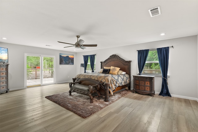 bedroom featuring ceiling fan, light wood-type flooring, access to exterior, and multiple windows