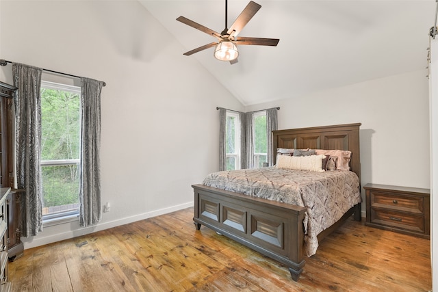 bedroom featuring ceiling fan, wood-type flooring, and high vaulted ceiling