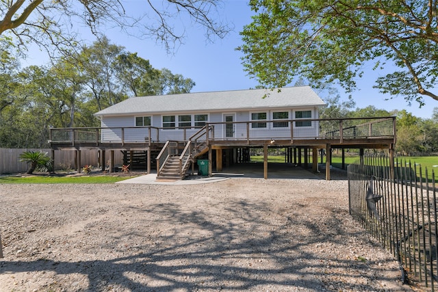 view of front of home featuring a carport and a wooden deck