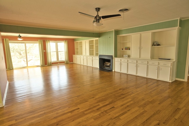 unfurnished living room with ornamental molding, ceiling fan, and light hardwood / wood-style floors