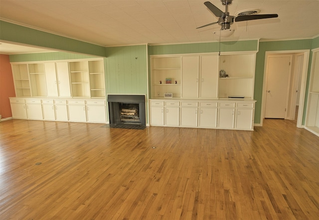 unfurnished living room with ornamental molding, light hardwood / wood-style floors, and ceiling fan