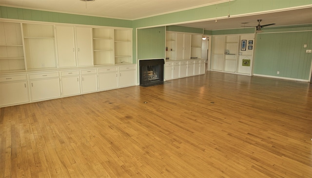 unfurnished living room featuring ornamental molding, light hardwood / wood-style flooring, and ceiling fan