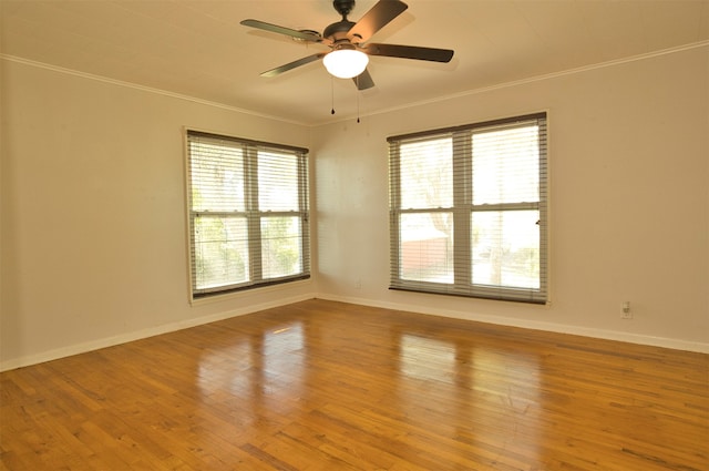 unfurnished room featuring plenty of natural light, light hardwood / wood-style flooring, and ornamental molding