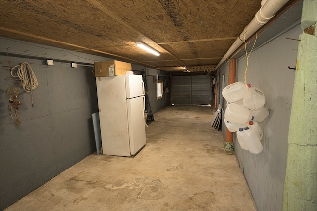 basement with white refrigerator