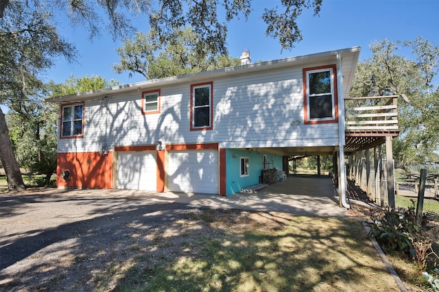 view of front of house with a garage and a carport