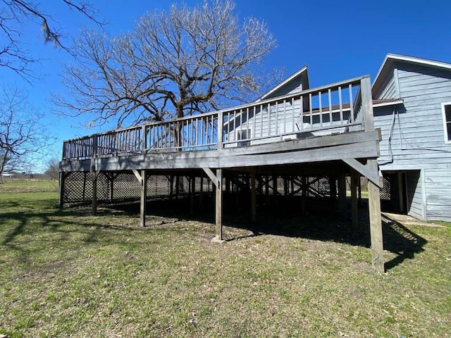 back of property with a deck and a lawn