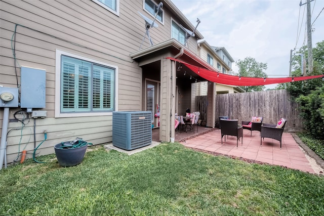 view of yard with central AC and a patio