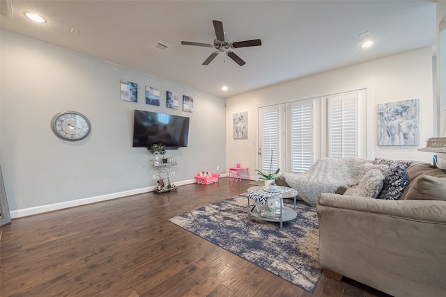 living room with dark wood-type flooring and ceiling fan