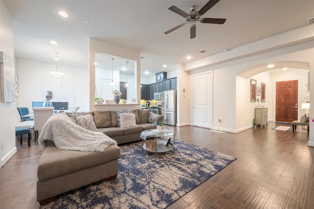 living room featuring dark hardwood / wood-style floors and ceiling fan