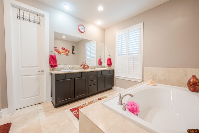 bathroom with double vanity, a relaxing tiled tub, and tile patterned flooring