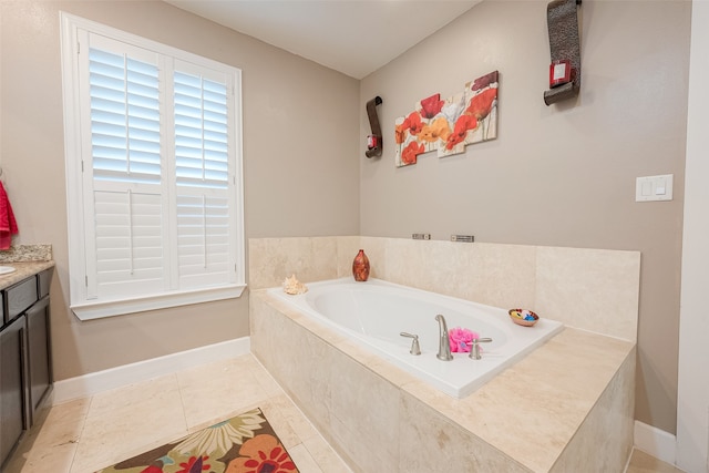 bathroom featuring tile patterned floors, vanity, and tiled tub