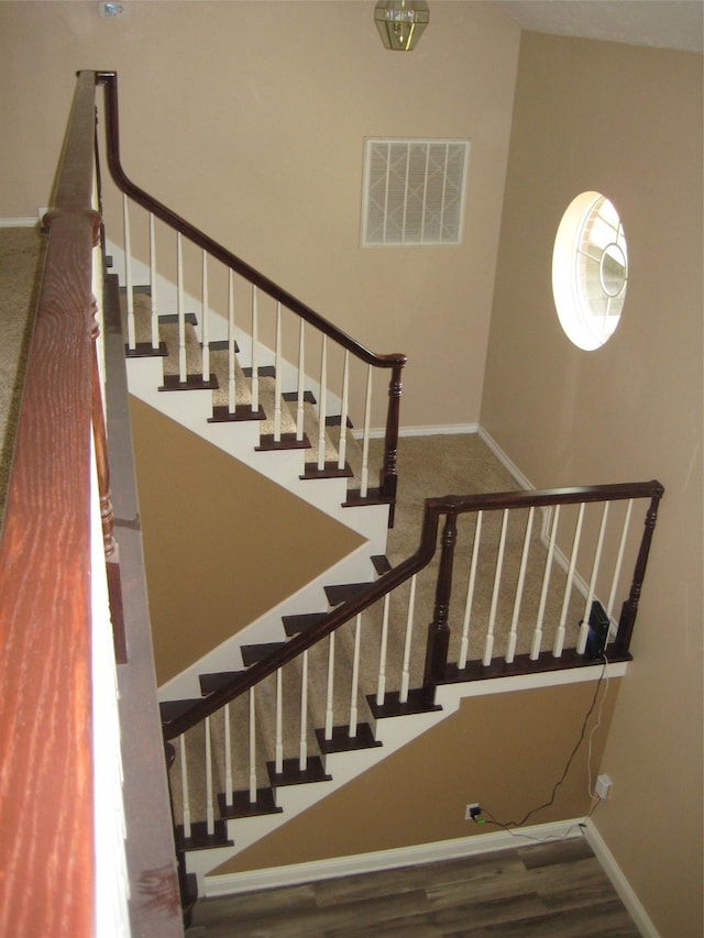 stairs featuring dark hardwood / wood-style floors