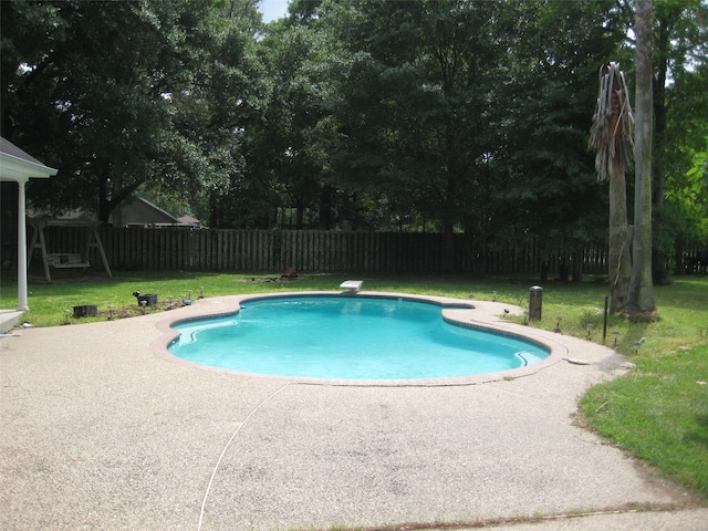 view of pool featuring a patio area and a yard