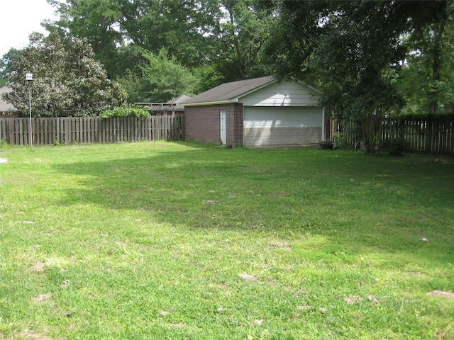 view of yard featuring a garage and an outdoor structure