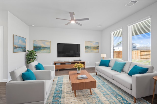 living room featuring wood-type flooring and ceiling fan