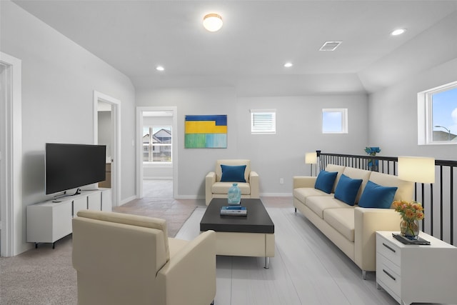 living room featuring light colored carpet and a healthy amount of sunlight